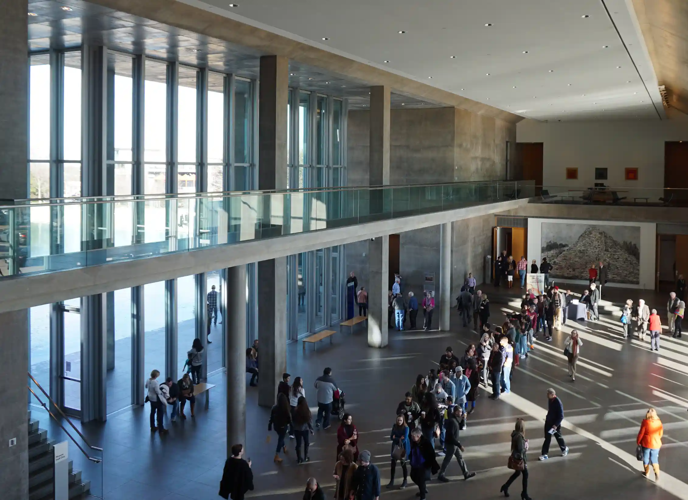 A lobby of a museum with patrons milling about.