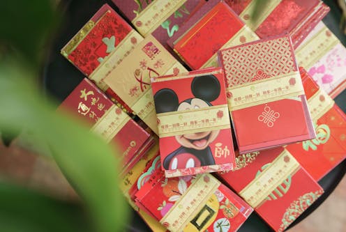 What is the story of hongbao, the red envelopes given out at celebrations like Lunar New Year?
