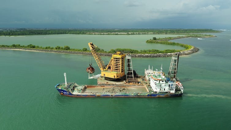 a dredge ship taking sand from the sea in Indonesia.