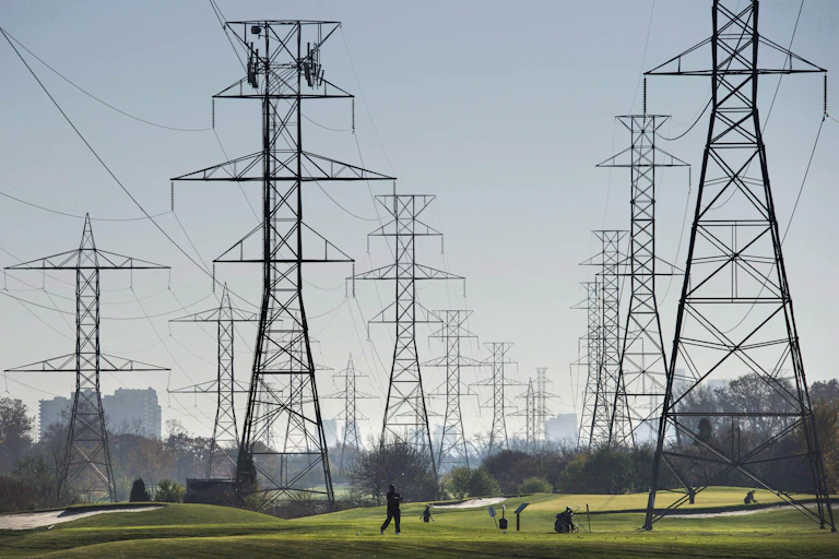 Hydro towers are seen over a golf course