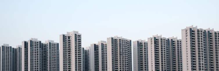 Exterior photo of a row of very similar high-rise residential towers
