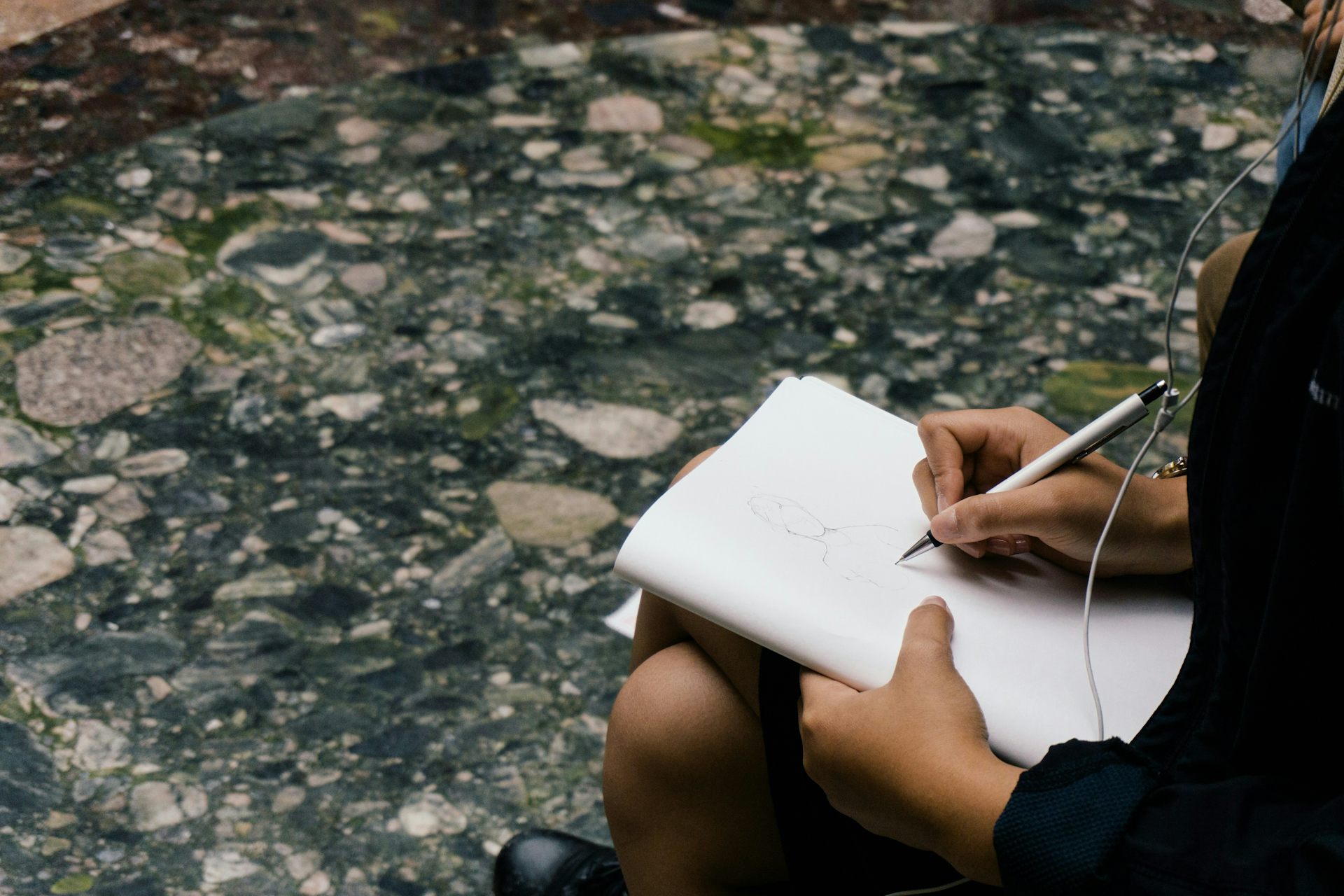 A woman with a sketch pad.