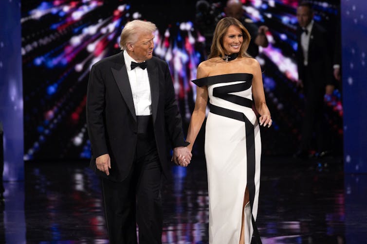 Donald Trump and First Lady Melania Trump dance on a stage.