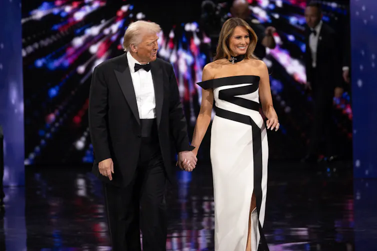 Donald Trump and First Lady Melania Trump dance on a stage.