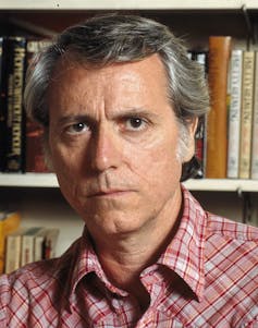 Don DeLillo photographed in front of a book shelf