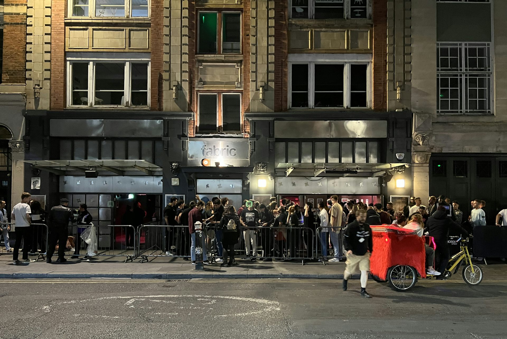 A group of young people queueing up outside a nightclub in London.