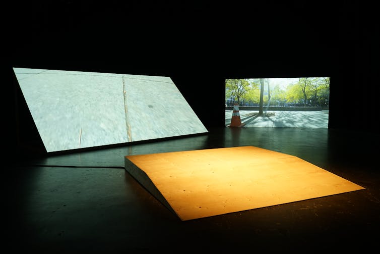 The sound of skateboarding gives skaters a healing method to connect to town 3 Ramps next to lit screens