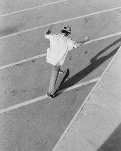 black and white photo of man skating