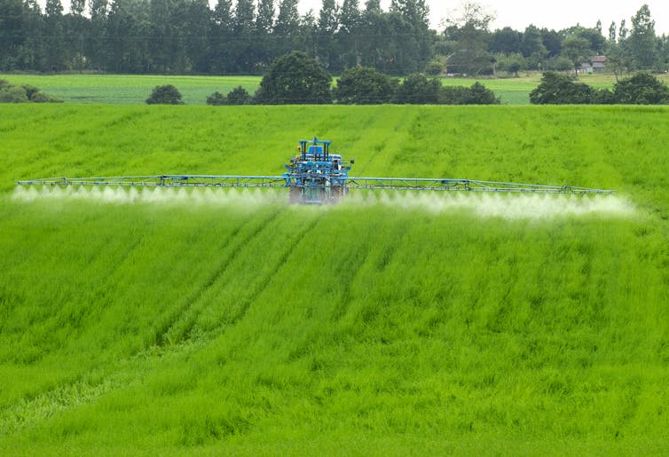 Engin agricole qui épande des pesticides