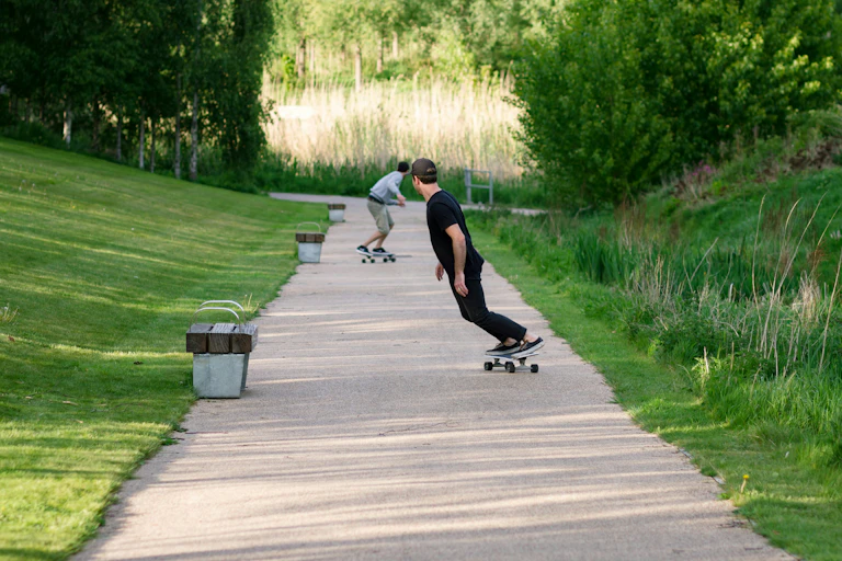 Two men skateboarding in a city part