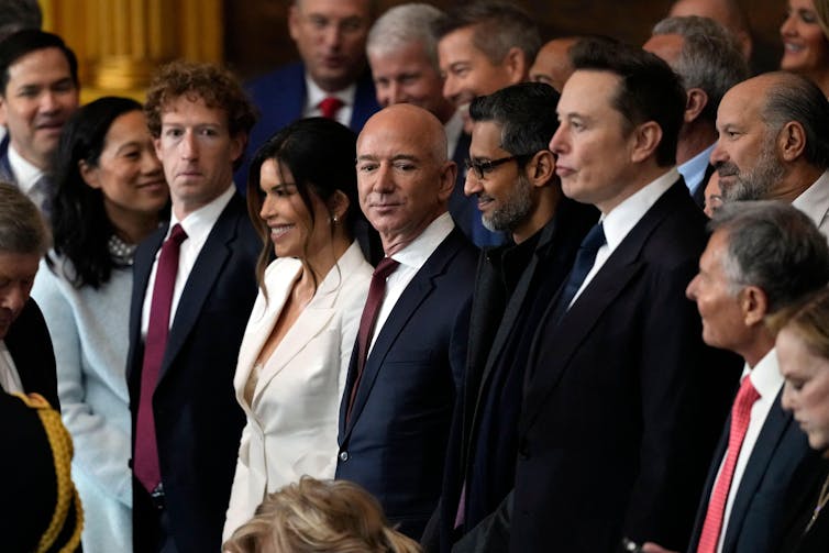 A crowd of men and women in formal attire.