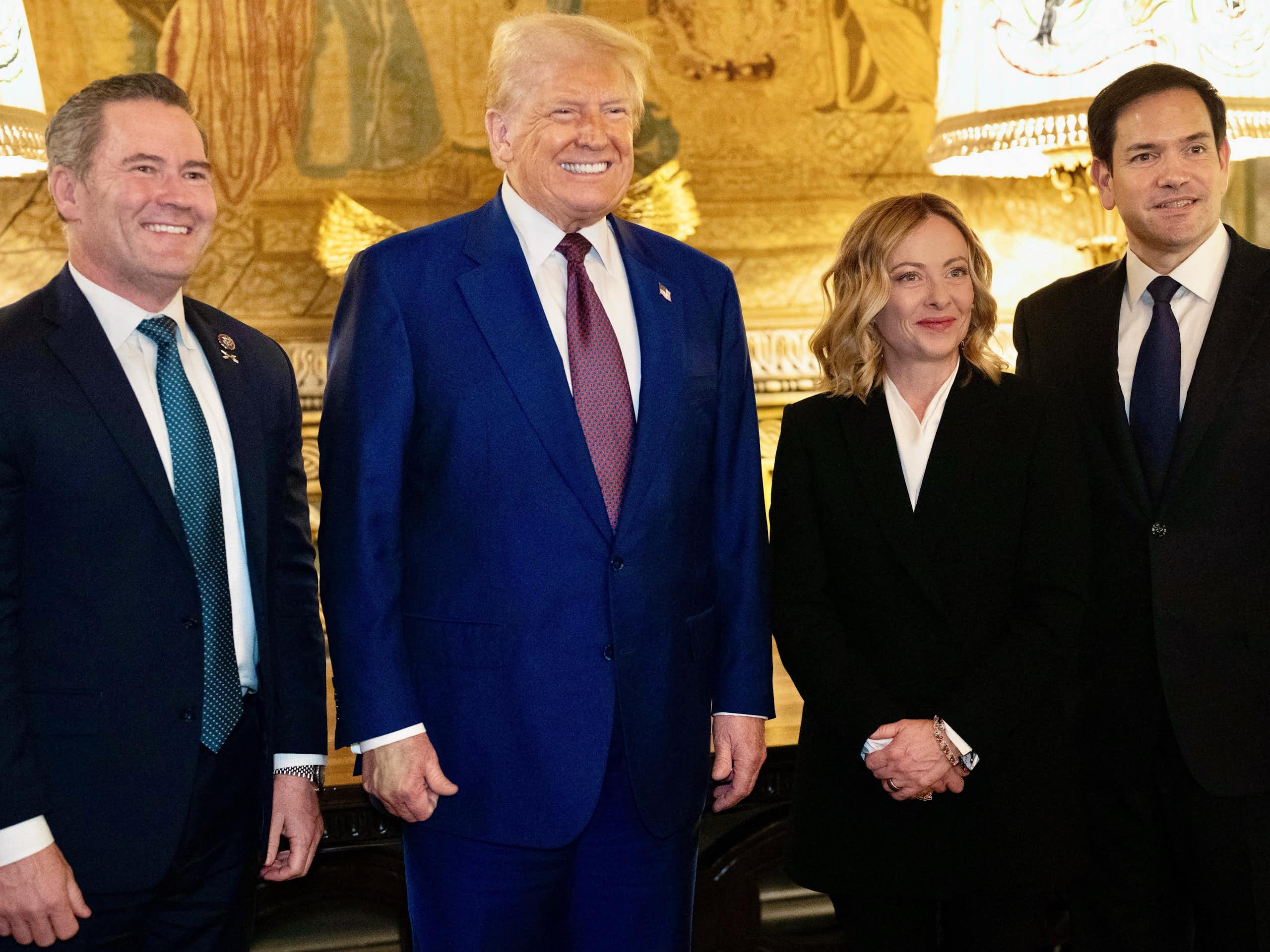 US national security adviser Mike Waltz, US president Donald Trump, Italian prime minister Giorgia Meloni and US Senator Marco Rubio are seen standing in a brightly lit room.
