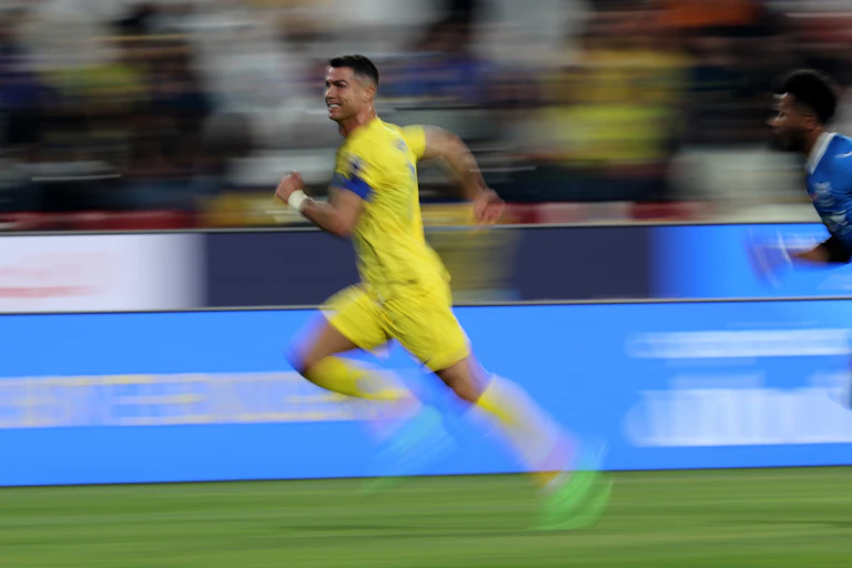 Soccer superstar Cristiano Ronaldo uses his speed to burst away from an opponent.