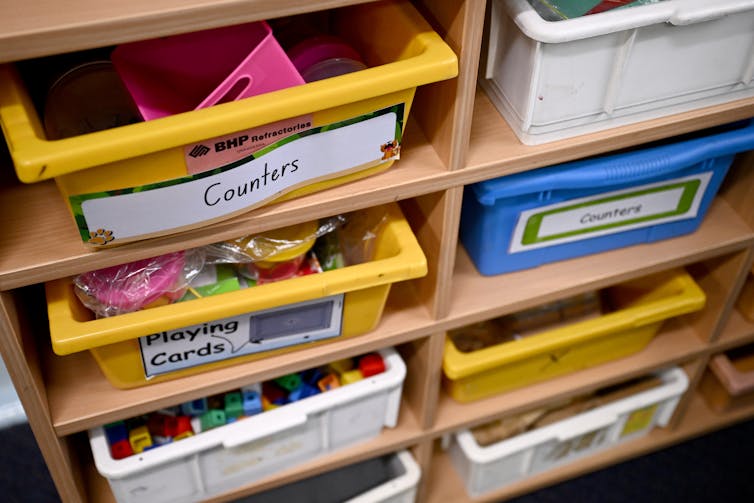 Trays in a classroom for 'counters' and 'playing cards'.