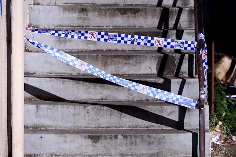 Concrete stairs with a blue police tape in front of them.