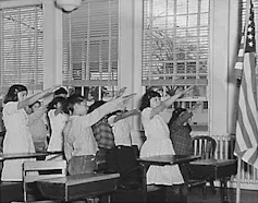 US schoolchildren performing the Bellamy salute to the flag of the United States, 1941