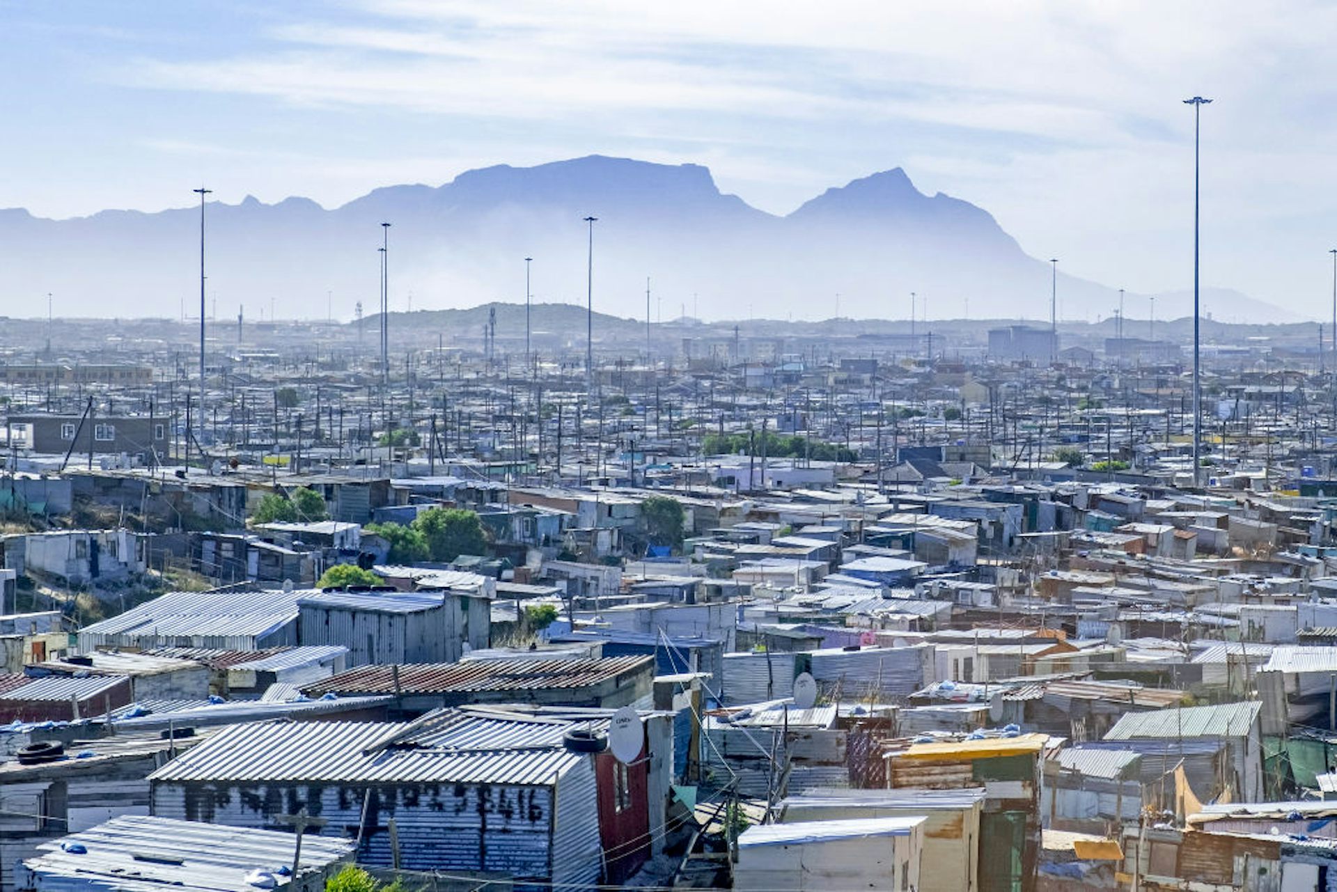 Shanty town with a mountain in the distance