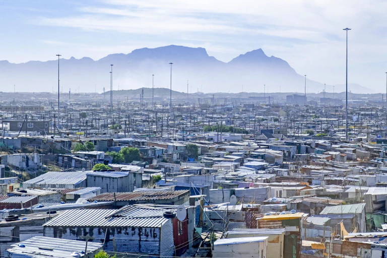 Shanty town with a mountain in the distance