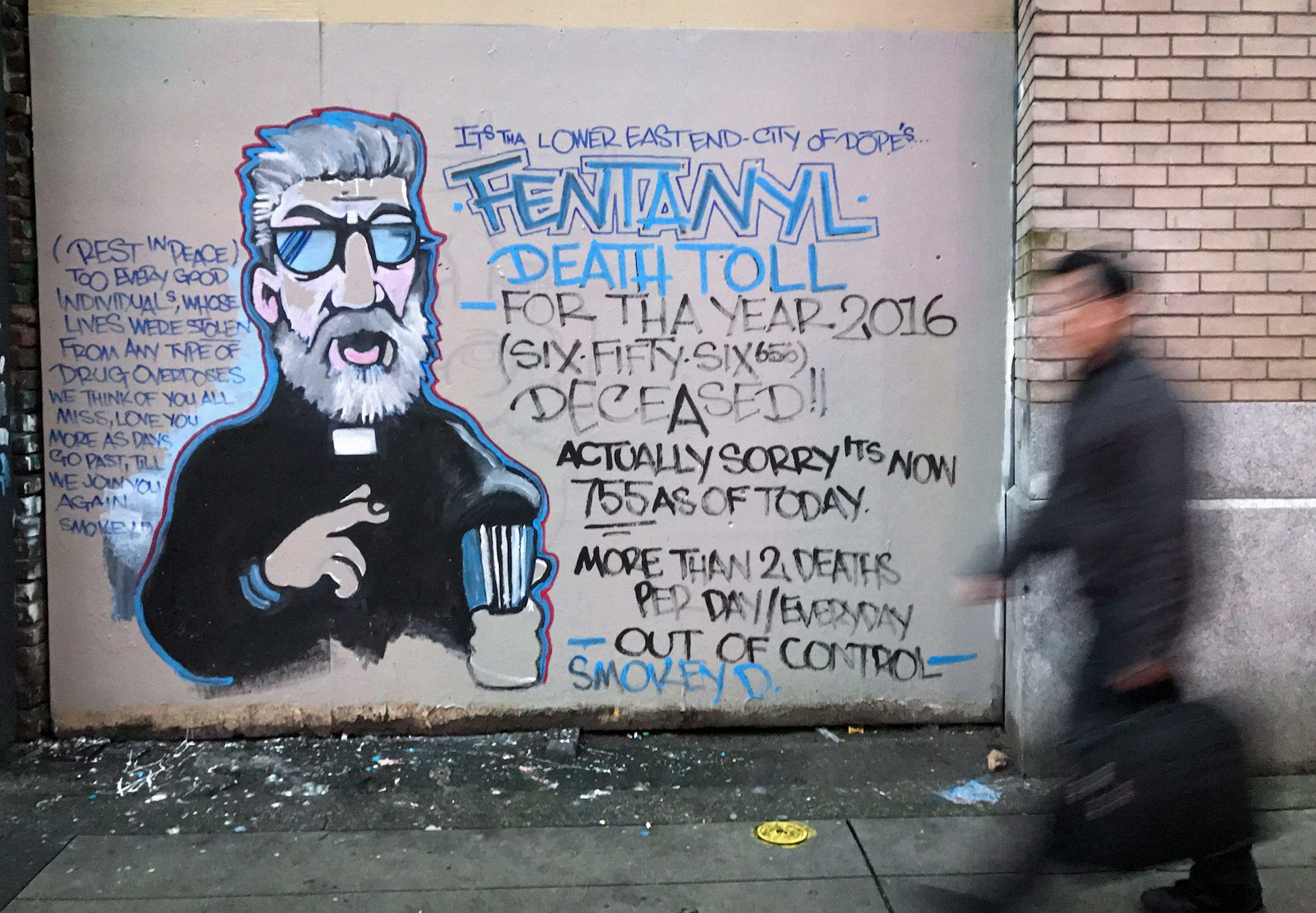Man walks past mural in a Vancouver street