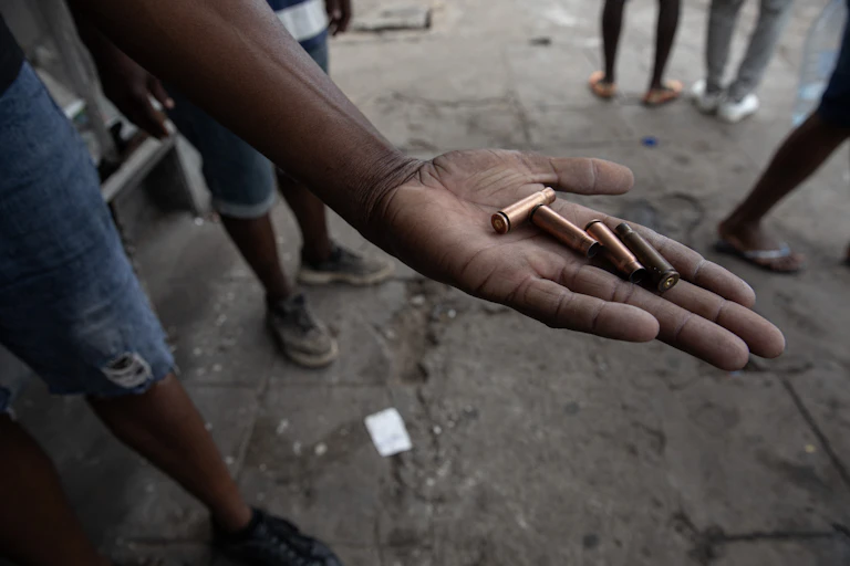 A protester shows bullet casings allegedly fired by police during a protest in Maputo on