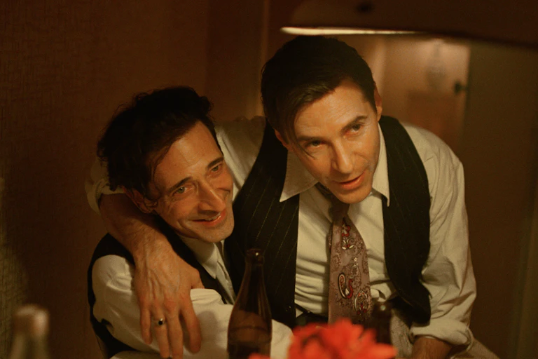 Two men dressed in 1940s garb highly emotional at their reunion after the war.