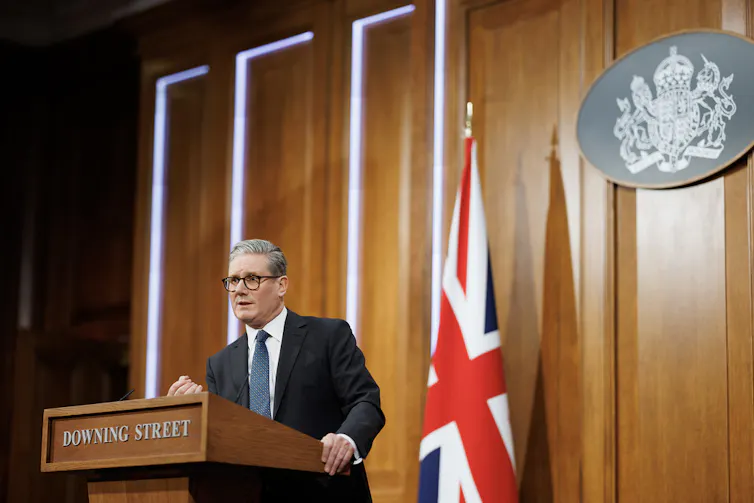 Keir Starmer speaking at a podium inside Downing Street