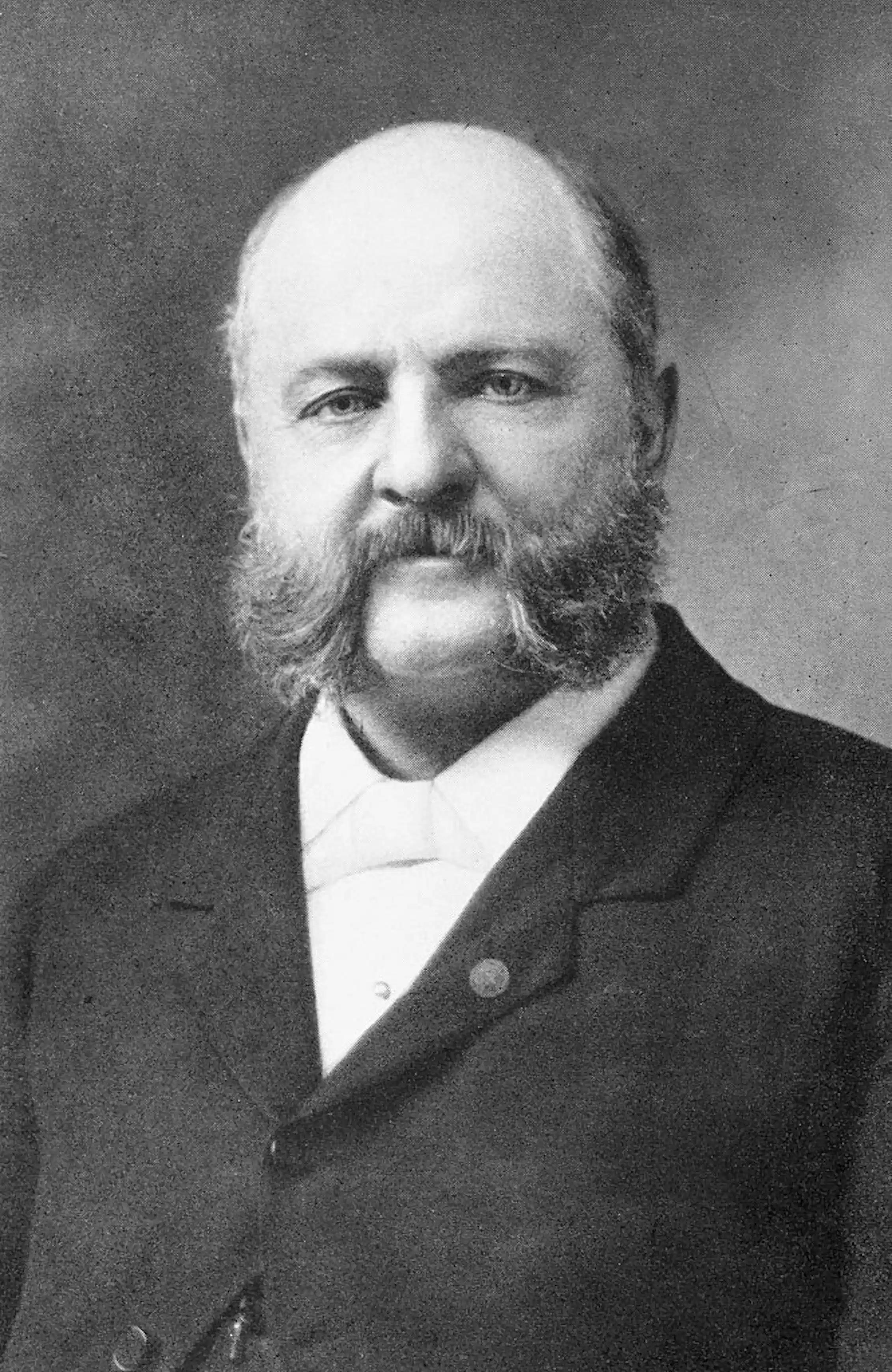 Portrait of bald man with mutton chops.