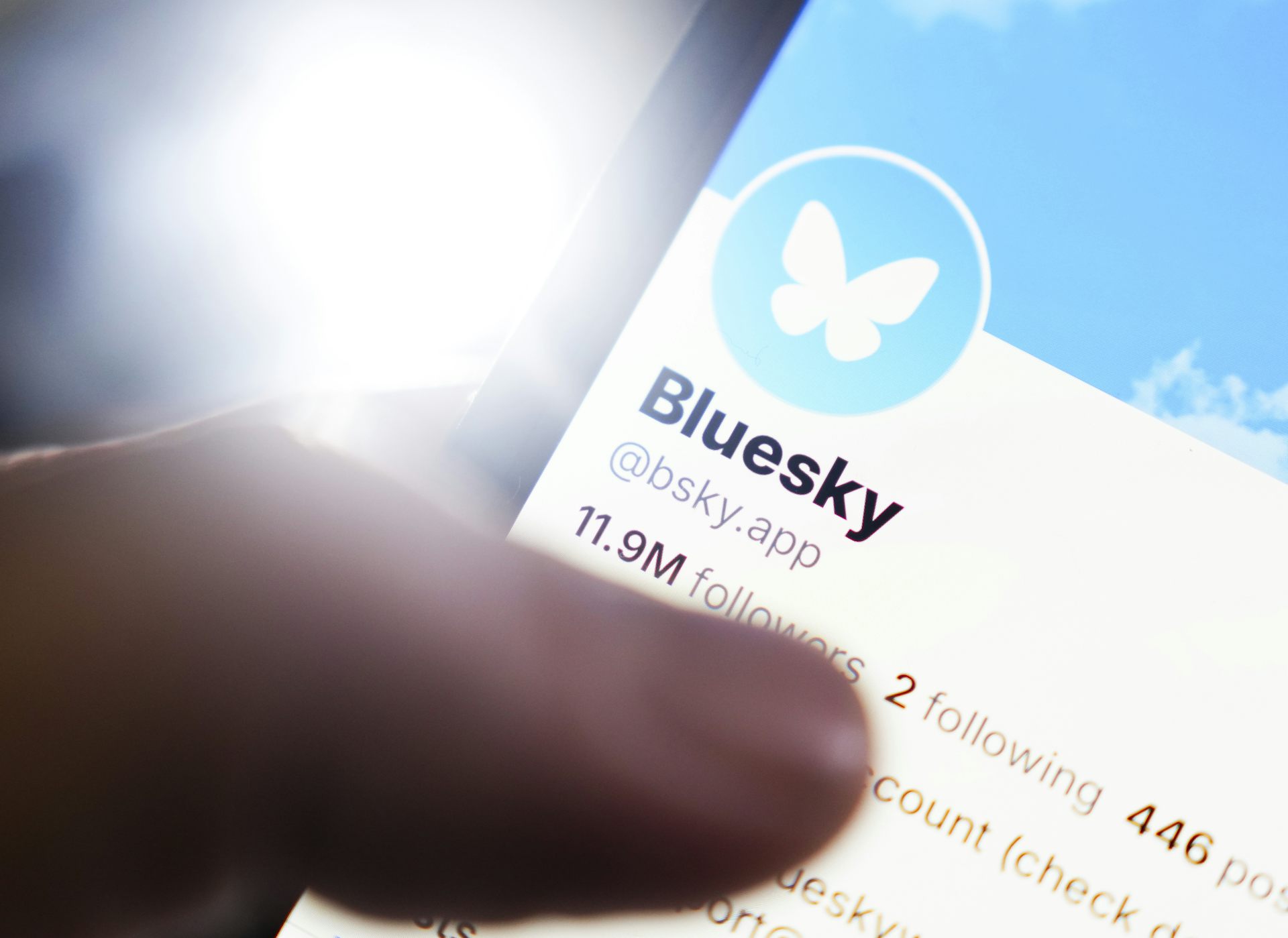 close up of a smartphone displaying the Bluesky app