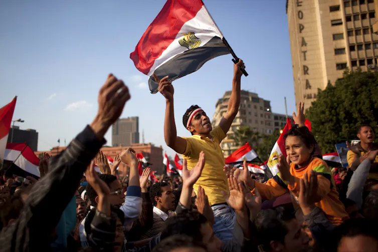 Man waves flag in a crowd