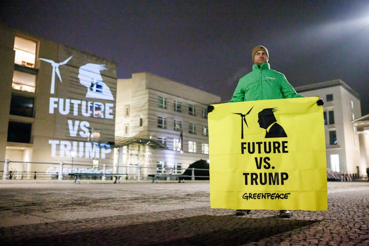 Man holds sign reading 'future vs Trump'