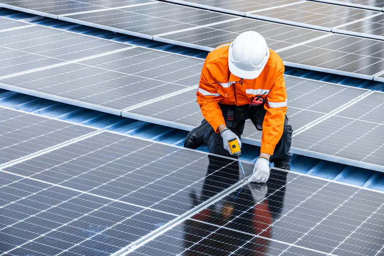 person installing solar panels