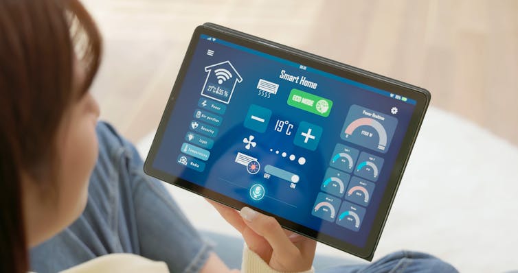 woman looks at tablet screen