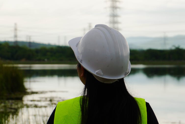 woman e engineer looks at electricity network