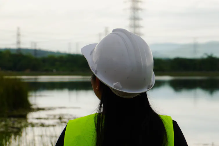 woman e engineer looks at electricity network