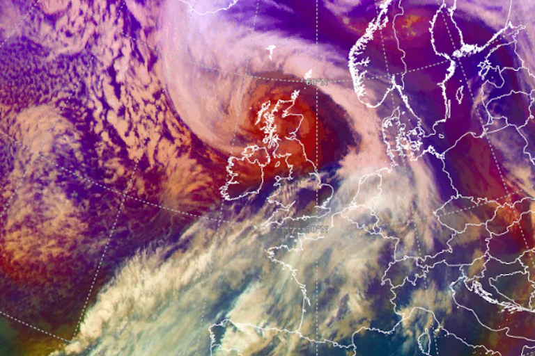 A satellite image of the UK and northern Europe in red and violet shades.