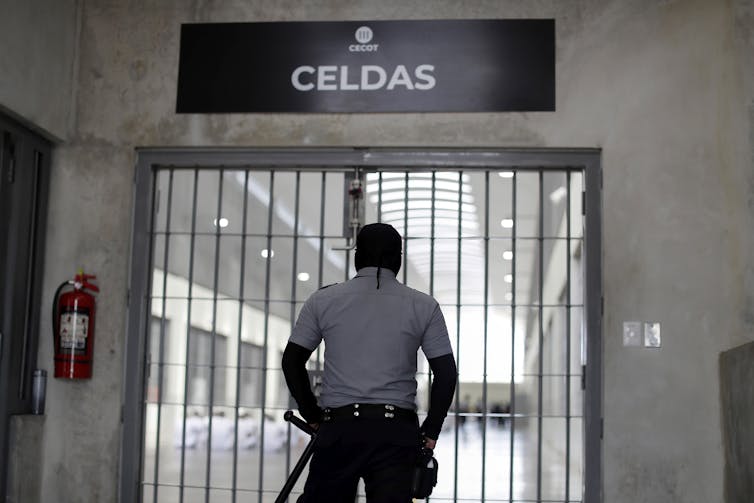 A guard watches over prisoners.