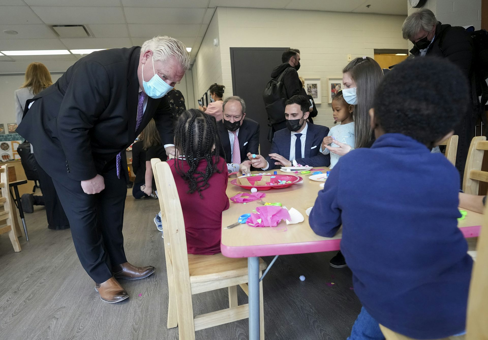 A man talks to children in a child care centre.