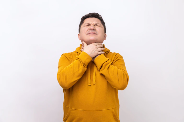 Man holding his neck in pain.