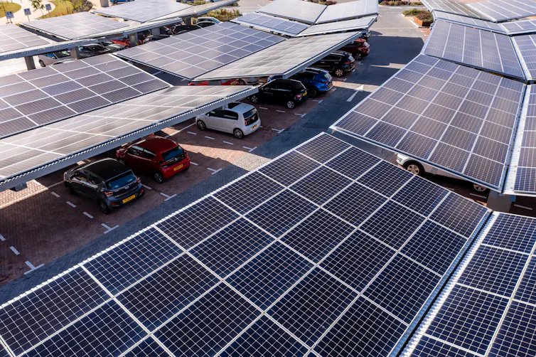 car park and car charging station with solar panels on the roof