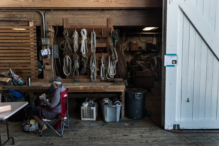 Trump electorate don't seem to be the impediment to weather motion many assume they're 3 A person sits mending rope in a workshop.