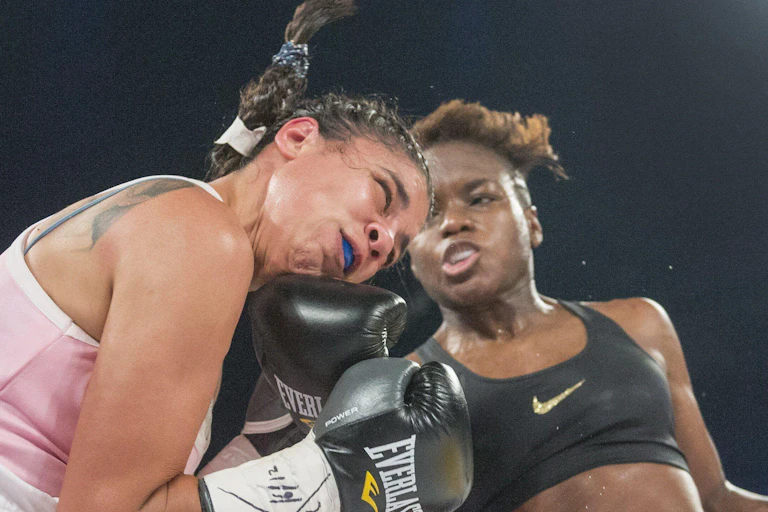 Nicola Adams, right, of the United Kingdom, lands a right to the head of Soledad Macedo, of Uraguay.