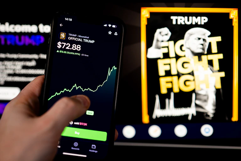 Hand holding a smartphone with a green line graph rising to higher amounts.