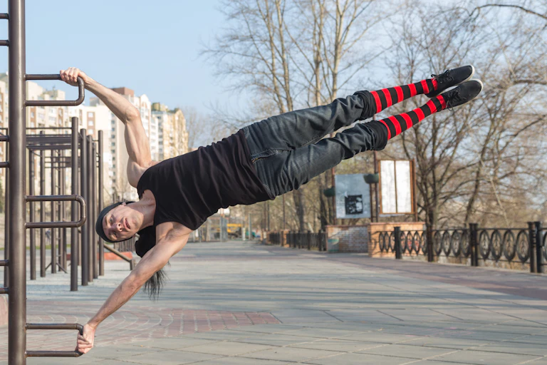 A person performs a flagpole hold.