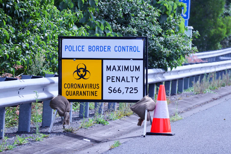 A police road sign showing penalties for breaking COVID restrictions.