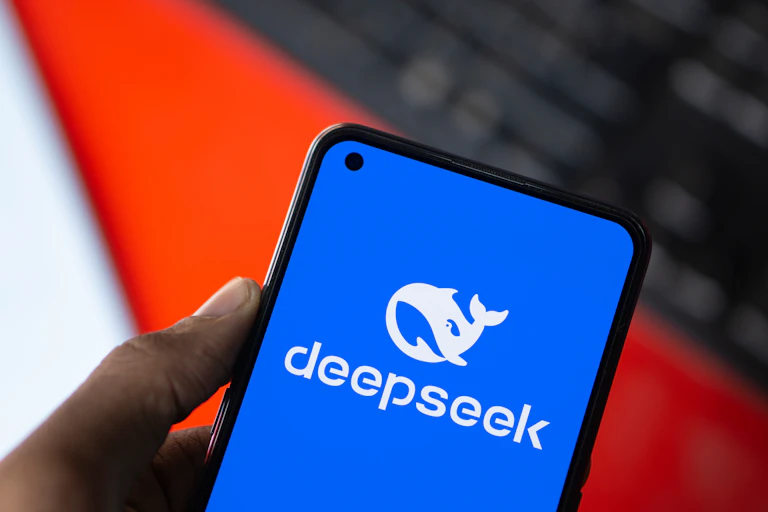 A blue app screen shows a white whale logo with the words deepseek under it.