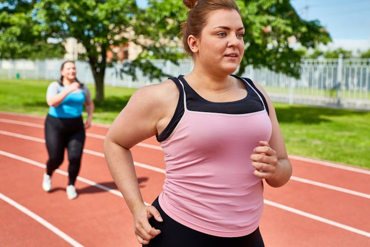 Two young women job on a track.