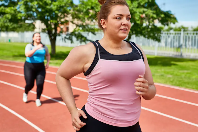 Two young women job on a track.