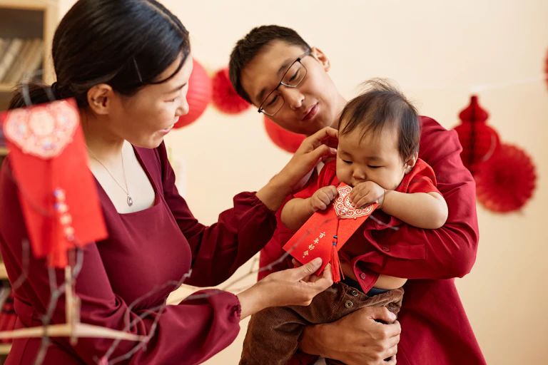 A family on lunar new year with red envelopes.
