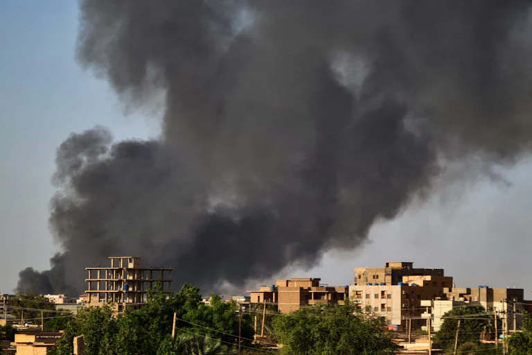 Smoke rises above buildings amidst war