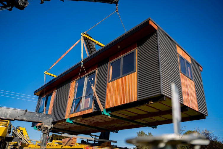 A portable house being transported to a site.